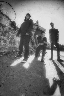 black and white photo of shadowplay rock super group standing in front of a brick wall from bands photo shoot