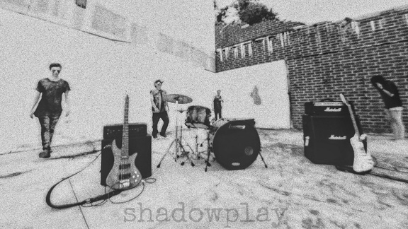 a black and white photo shadowplay bands members standing in front of a wall